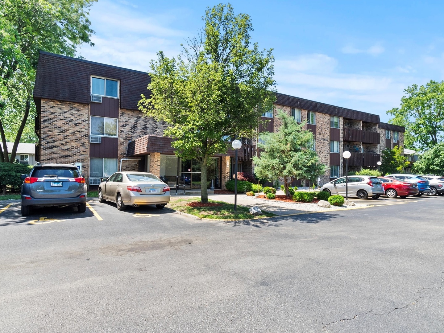 940 East Old Willow Road, Unit 305 Prospect Heights, IL 60070 - Photo 2 of 18 a view of a car parked in front of a brick house