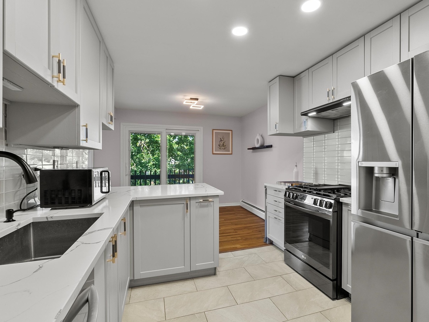 940 East Old Willow Road, Unit 305 Prospect Heights, IL 60070 - Photo 6 of 18 a kitchen with granite countertop a sink stove and refrigerator