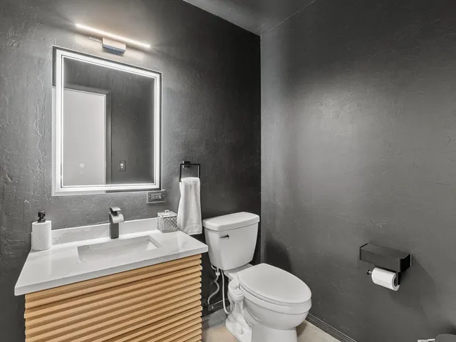 a bathroom with a sink toilet and mirror