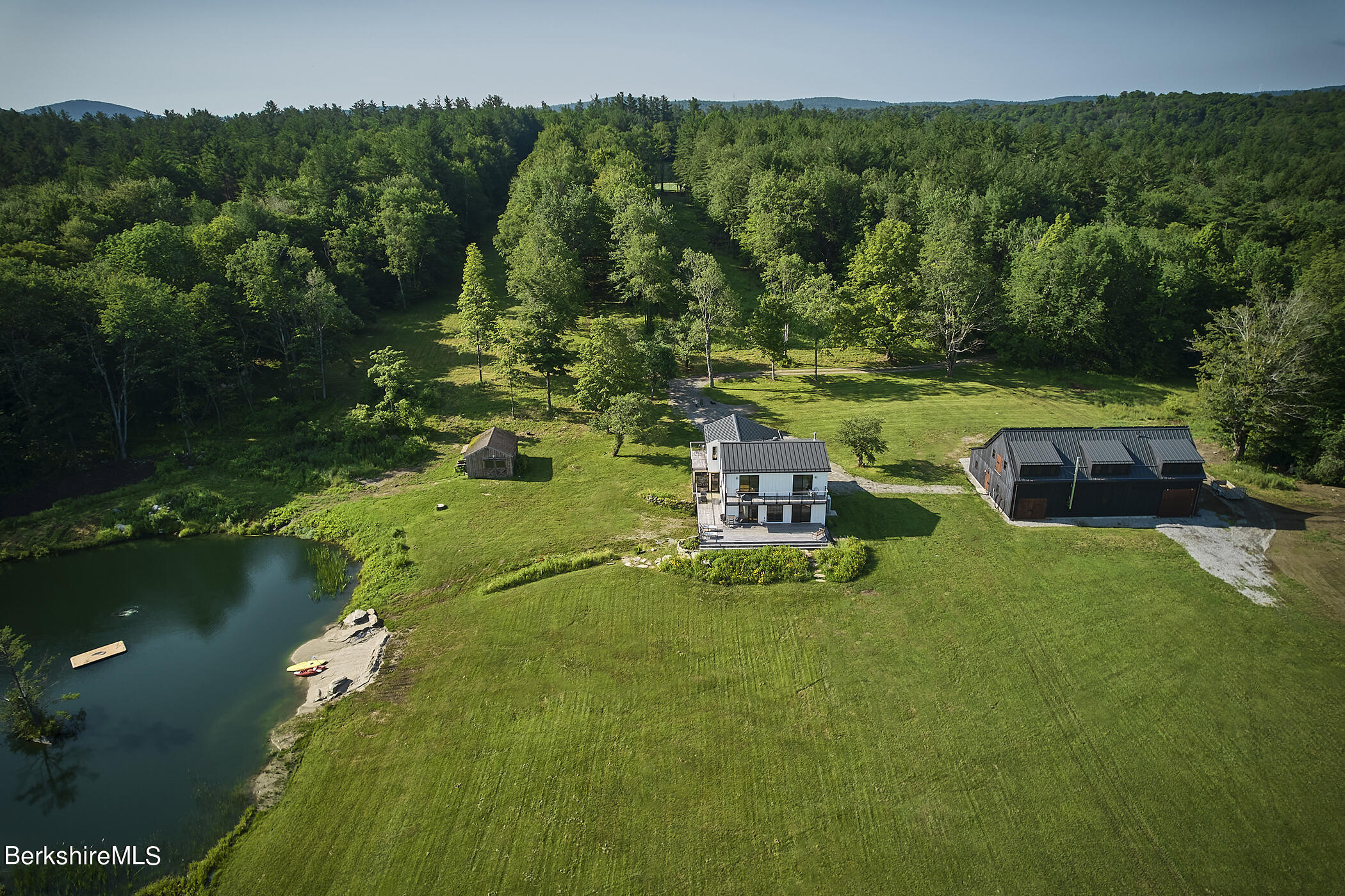 776 Bancroft Road Becket, MA 01223 - Photo 3 of 40 a swimming pool with outdoor seating and trees