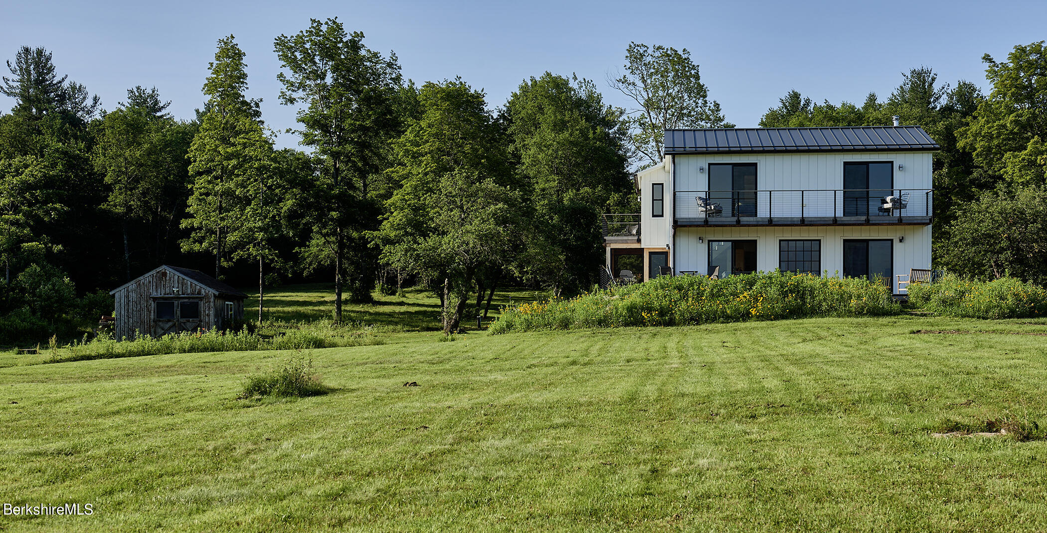 776 Bancroft Road Becket, MA 01223 - Photo 36 of 40 a view of a house with a backyard and a tree