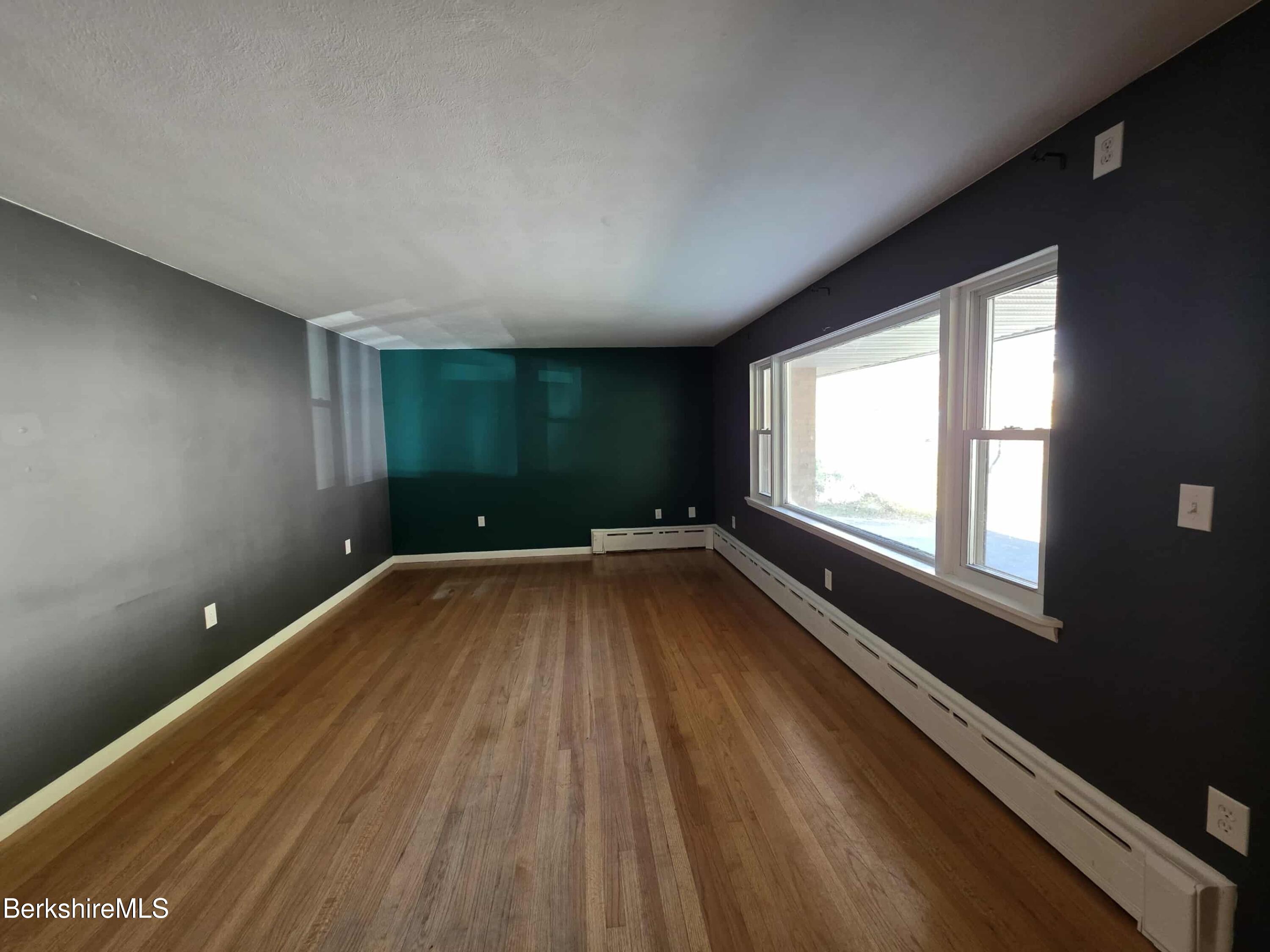 52 Richmond Street Adams, MA 01220 - Photo 11 of 25 a view of an empty room with wooden floor and a window