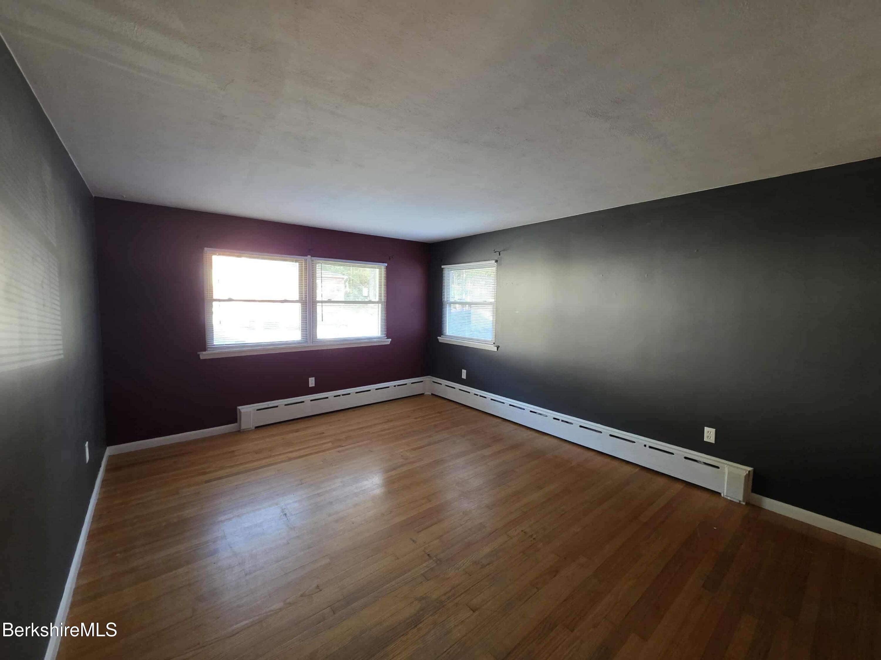 52 Richmond Street Adams, MA 01220 - Photo 17 of 25 an empty room with wooden floor and windows