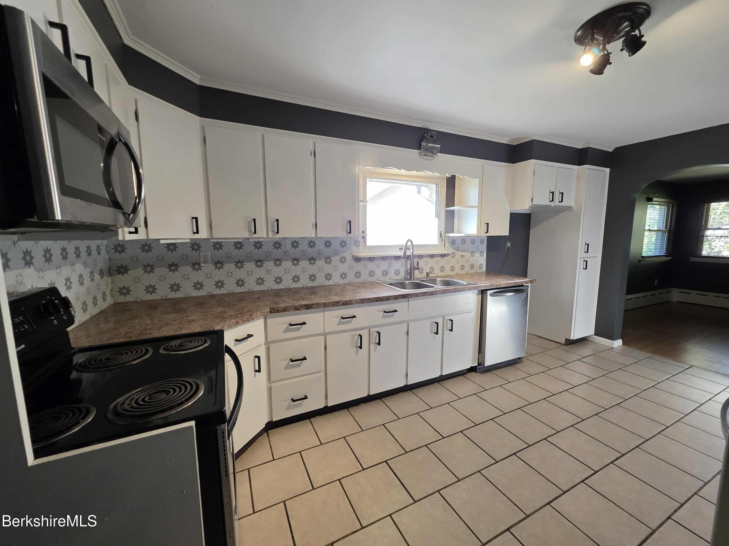 52 Richmond Street Adams, MA 01220 - Photo 5 of 25 a kitchen with stainless steel appliances granite countertop a sink stove and refrigerator