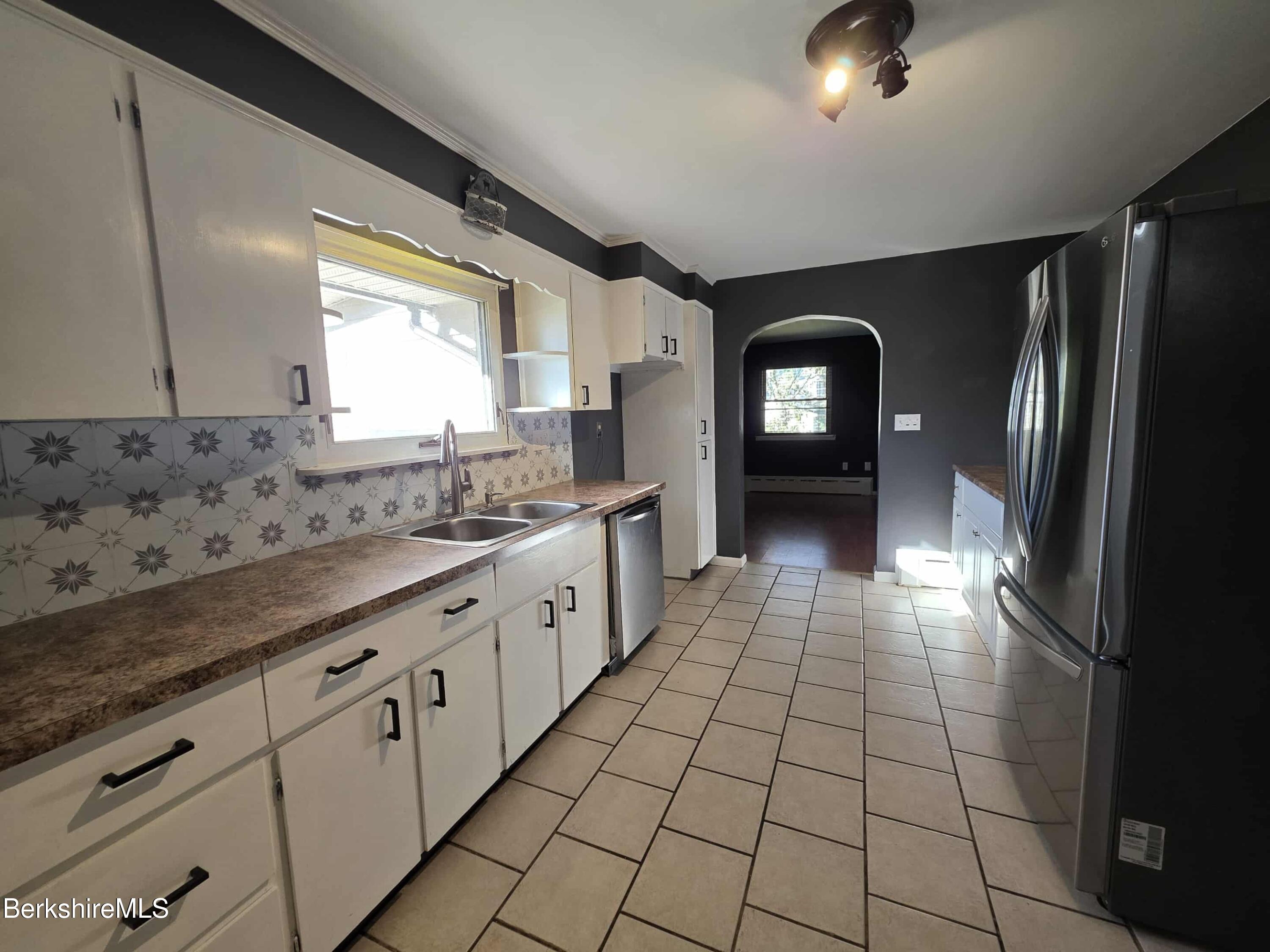 52 Richmond Street Adams, MA 01220 - Photo 6 of 25 a bathroom with a sink a mirror and a shower