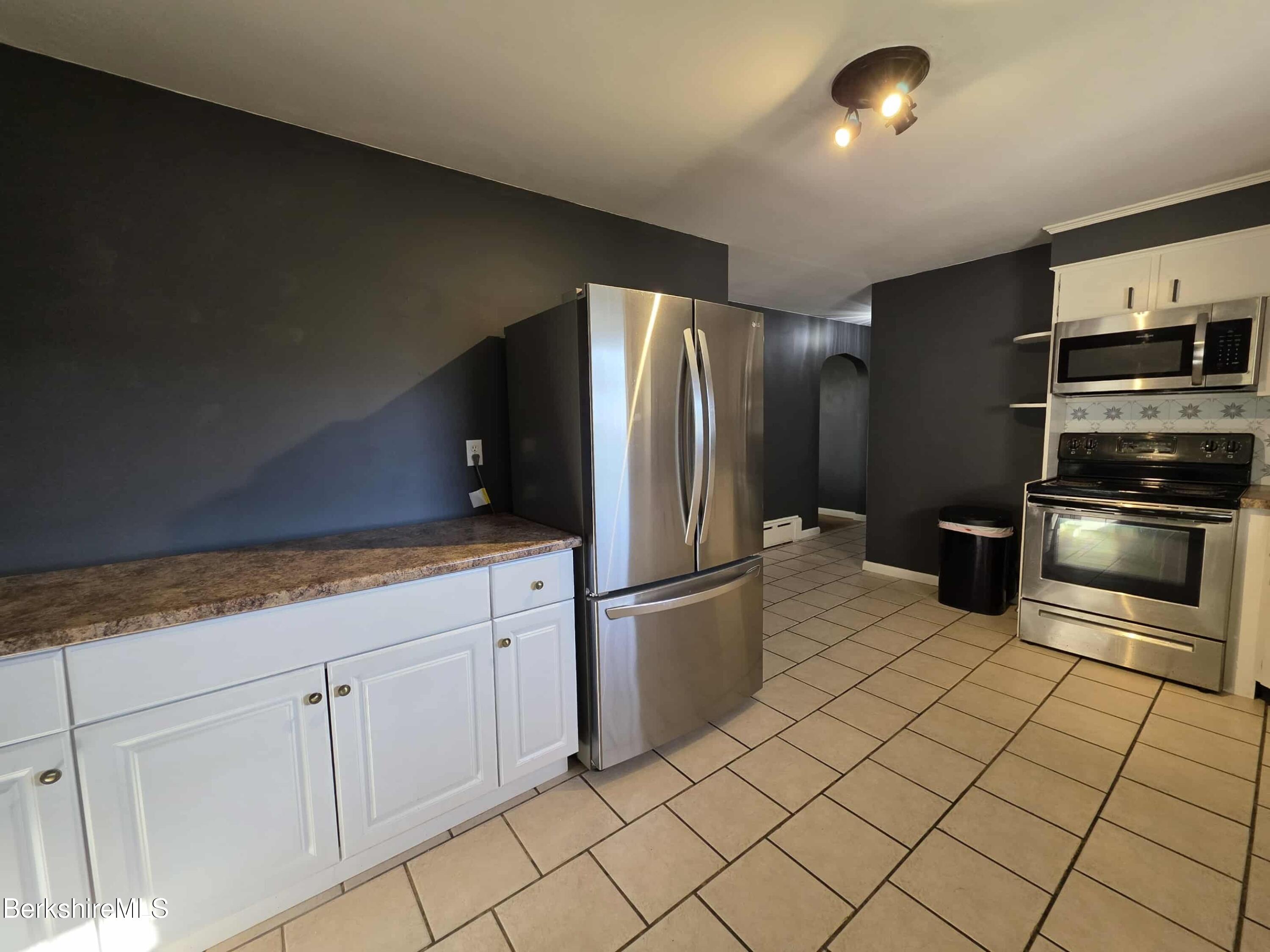 52 Richmond Street Adams, MA 01220 - Photo 7 of 25 a kitchen with cabinets and stainless steel appliances
