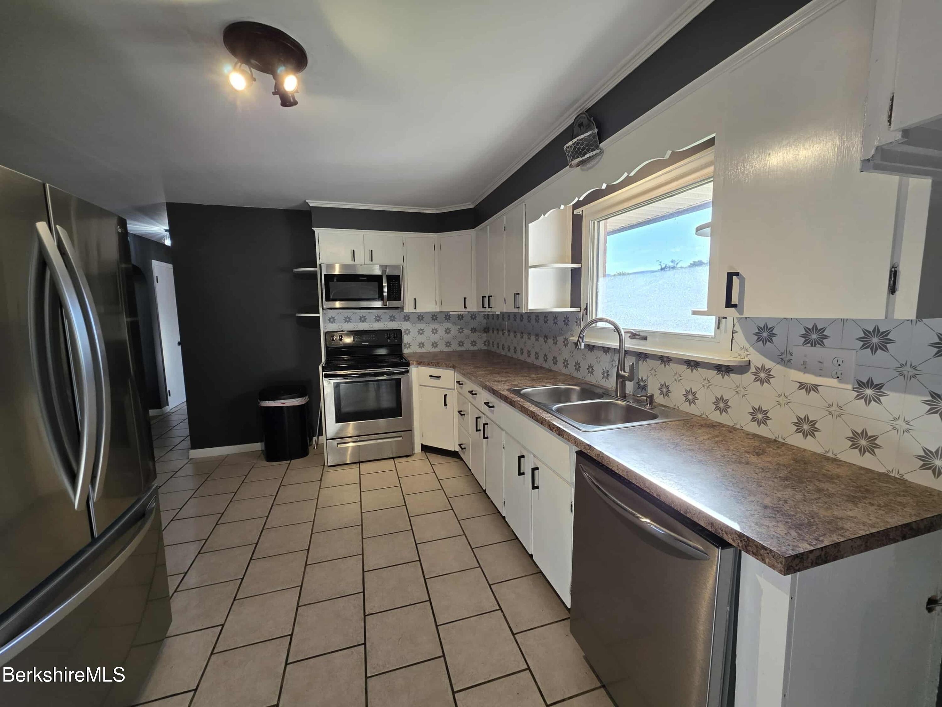 52 Richmond Street Adams, MA 01220 - Photo 8 of 25 a kitchen with stainless steel appliances granite countertop a sink stove and refrigerator