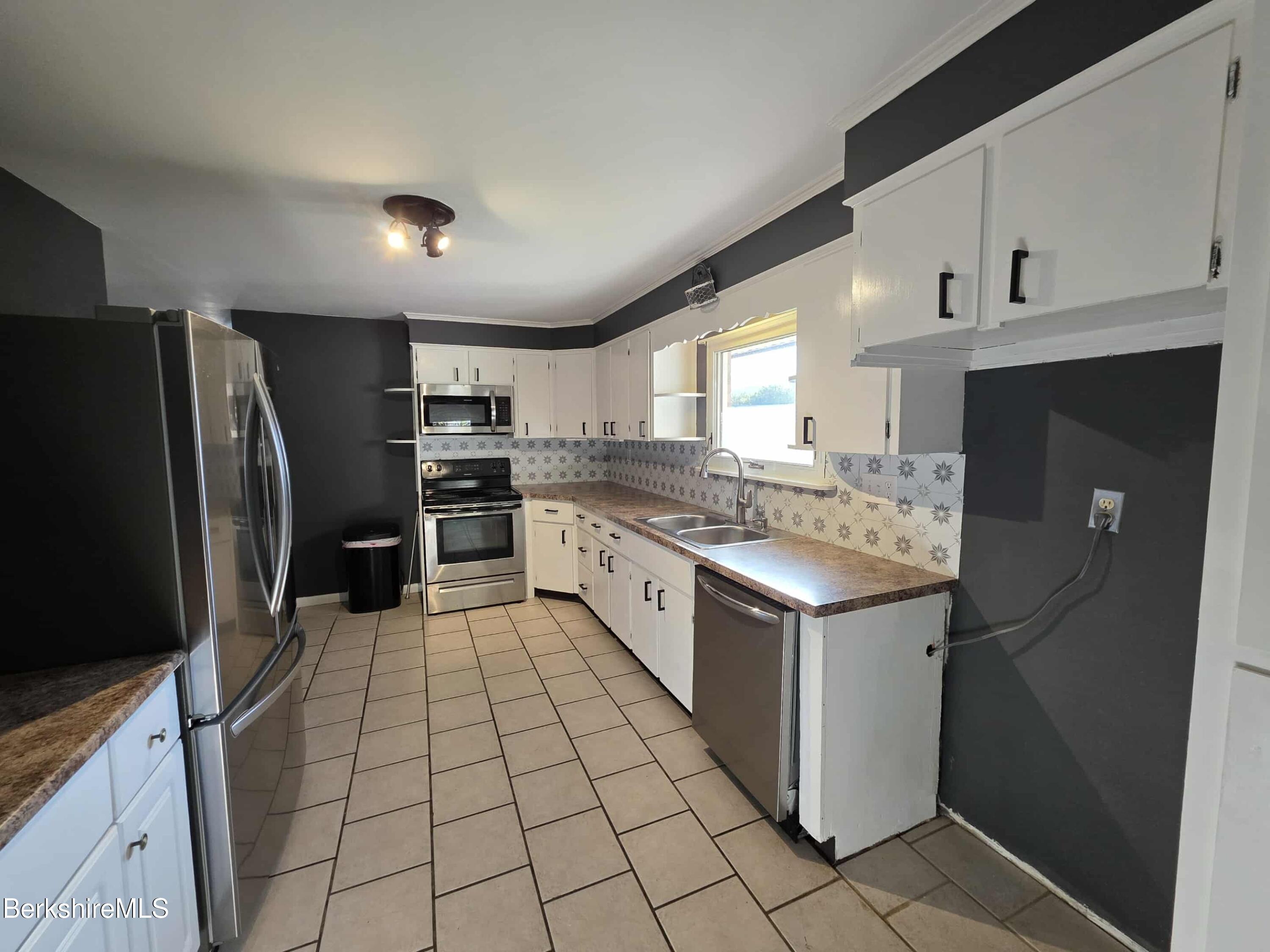 52 Richmond Street Adams, MA 01220 - Photo 9 of 25 a kitchen with stainless steel appliances granite countertop a refrigerator and a stove