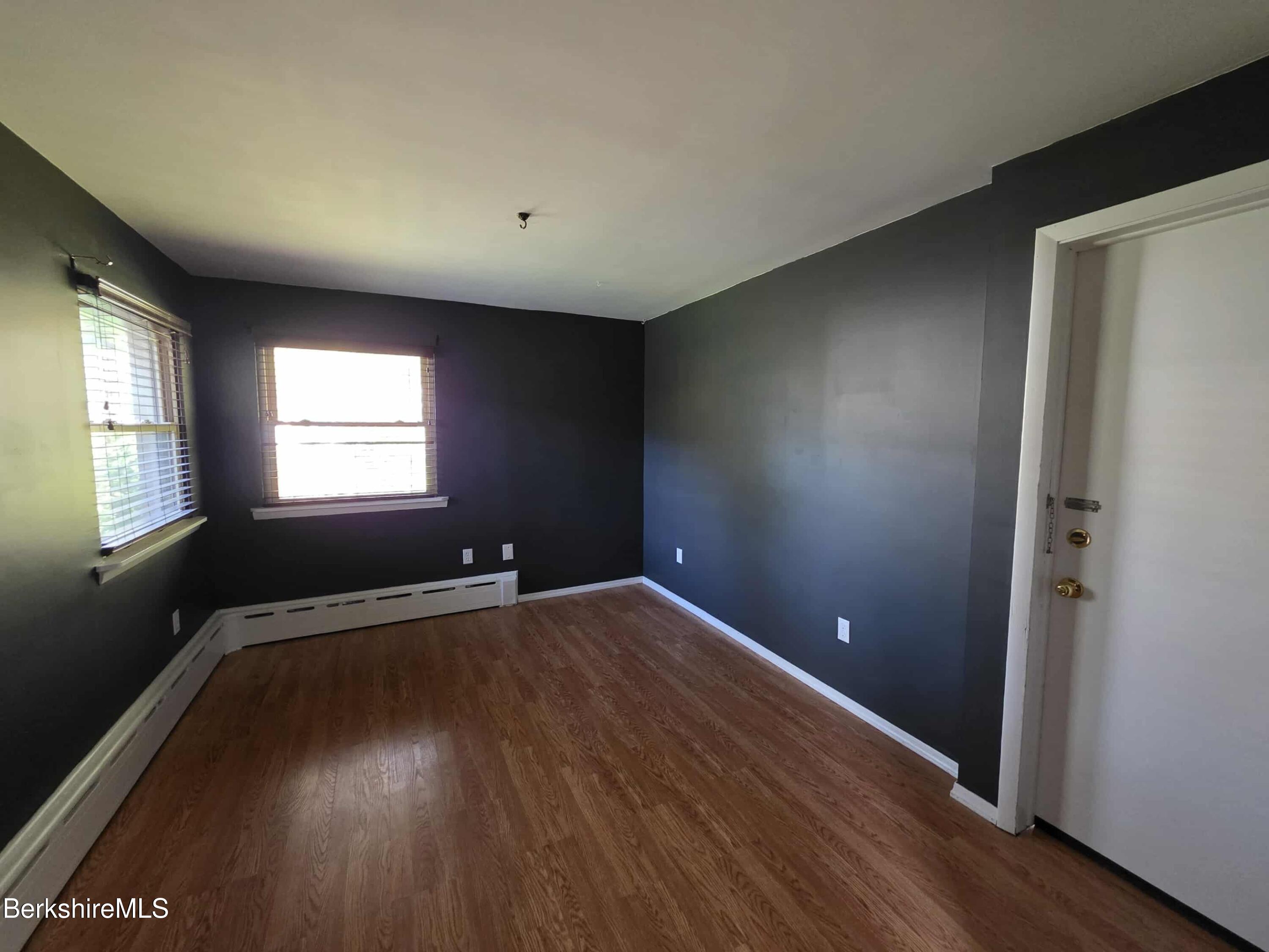 52 Richmond Street Adams, MA 01220 - Photo 10 of 25 an empty room with wooden floor and windows