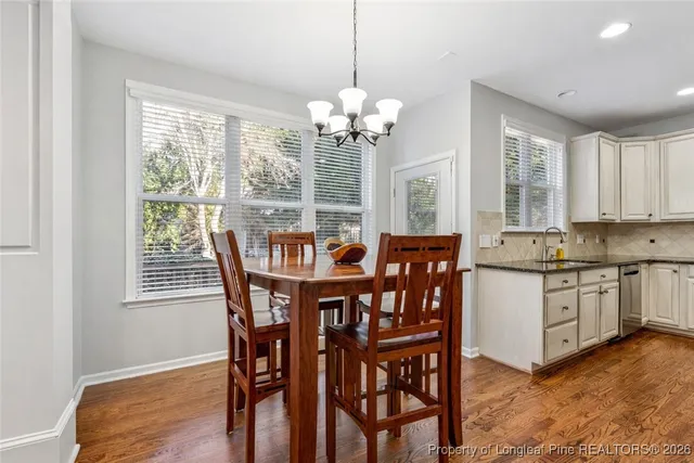 a bathroom with a granite countertop sink a toilet and a shower