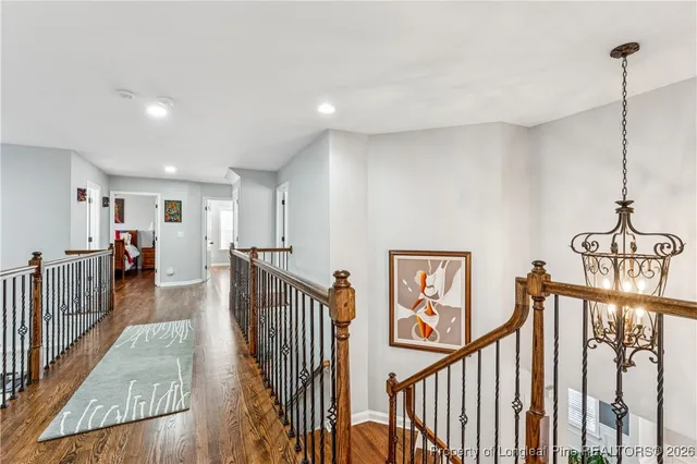 a room with gym equipment and wooden floor