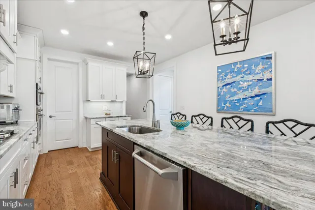 a kitchen with stainless steel appliances granite countertop a sink a counter space and cabinets