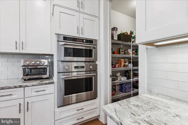 a kitchen with stainless steel appliances granite countertop a stove and a microwave