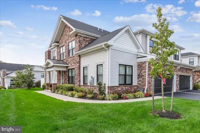 a view of a house with a yard and plants