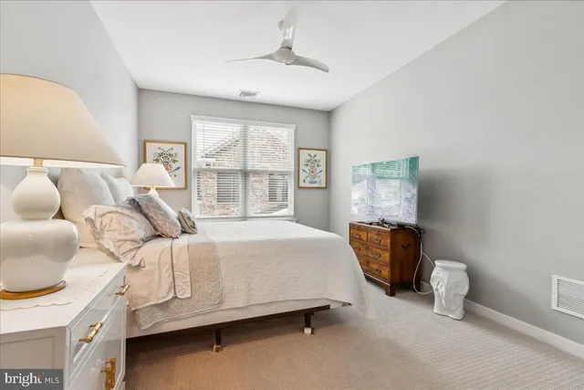 a bed room with a bed and a chair