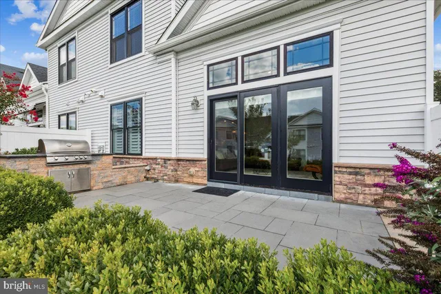 a view of a house with a yard and sitting area