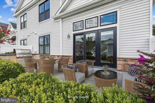 a view of a patio with table and chairs potted plants and a fountain