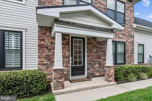 front view of a brick house with a large window