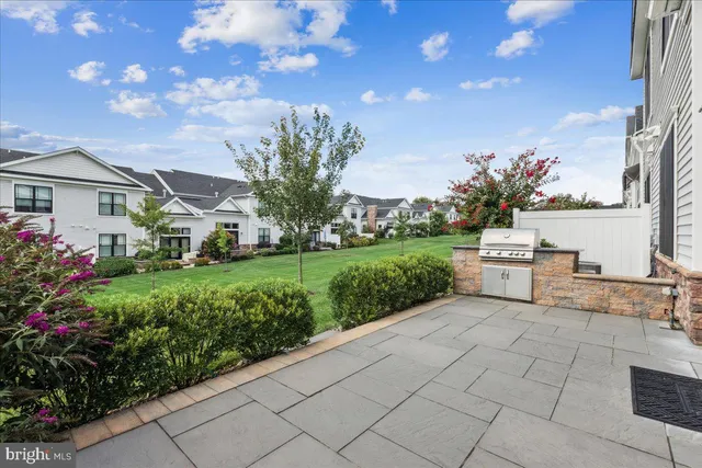 a house view with a sitting space and garden