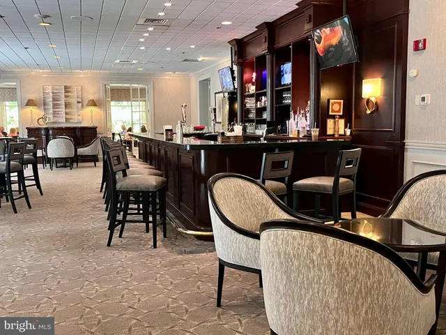 a room with lots of chairs and a view of dining table