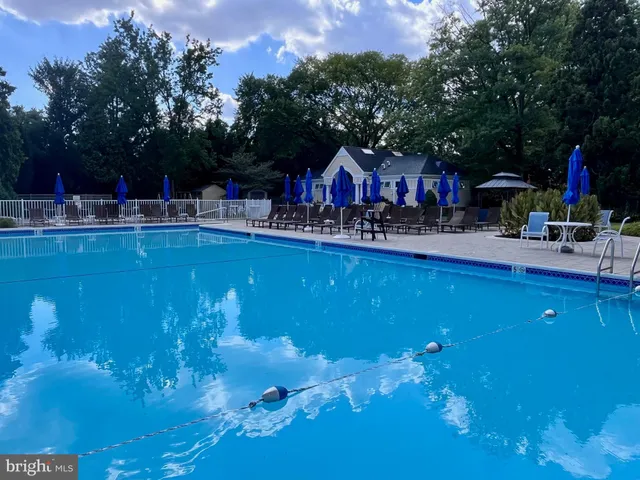 a view of a swimming pool with outdoor seating