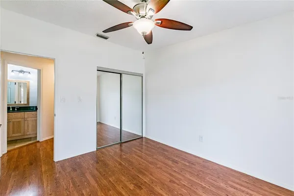 a view of empty room with wooden floor