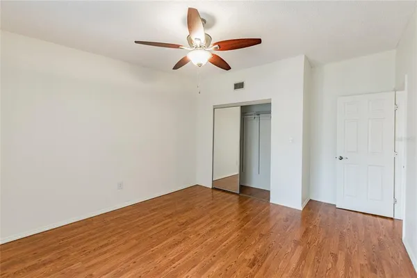 a view of an empty room with wooden floor