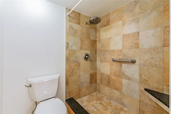 a bathroom with a toilet and shower