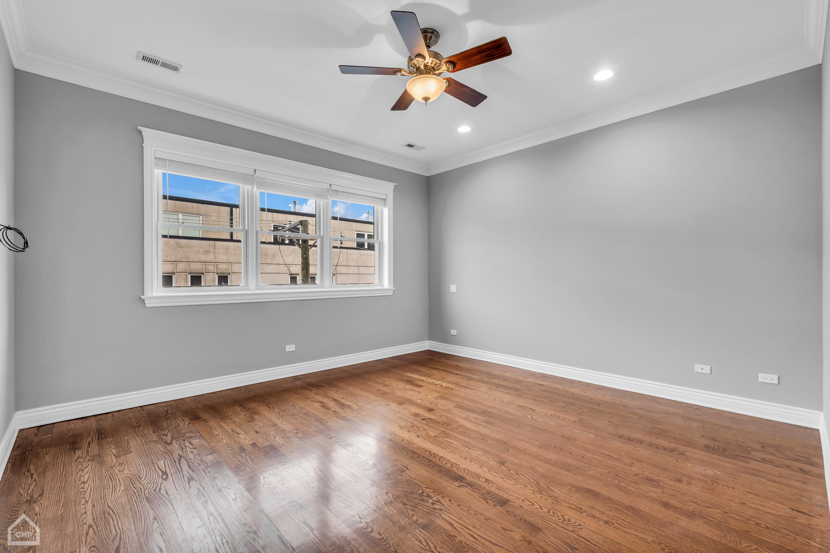 1248 West Jackson Boulevard, Unit 3E Chicago, IL 60607 - Photo 12 of 20 wooden floor in an empty room with a window
