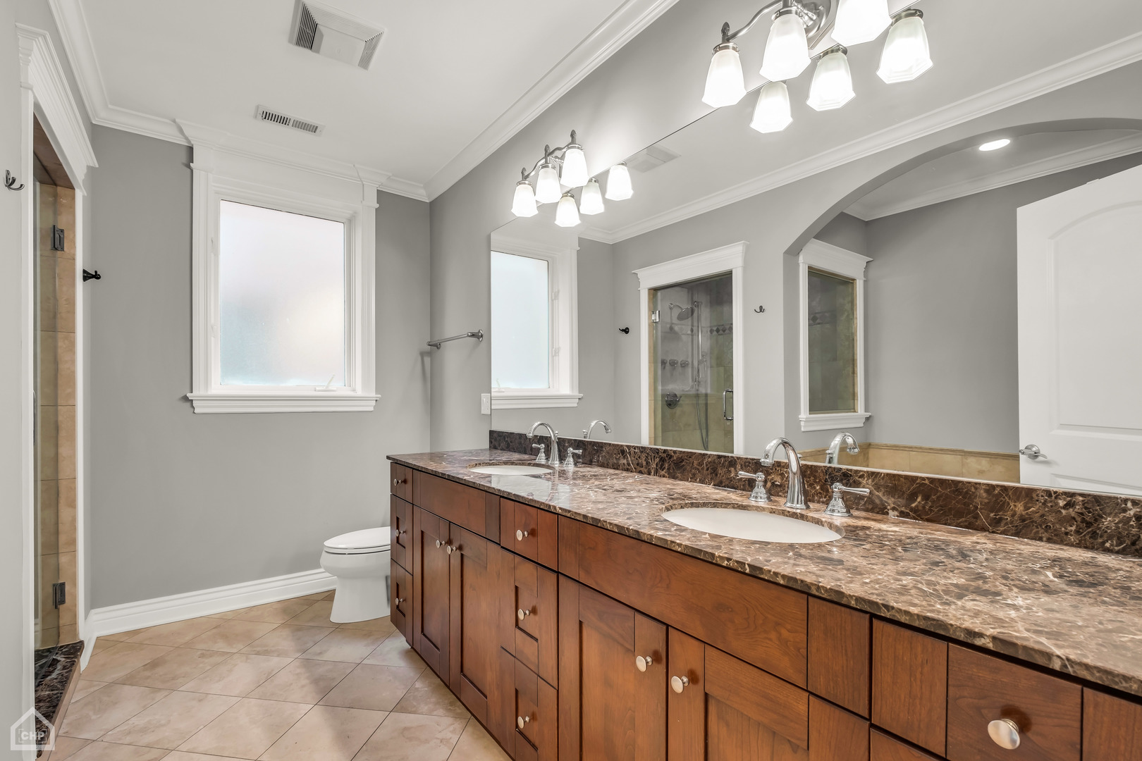 1248 West Jackson Boulevard, Unit 3E Chicago, IL 60607 - Photo 13 of 20 a bathroom with a granite countertop double vanity sink a mirror and a bathtub