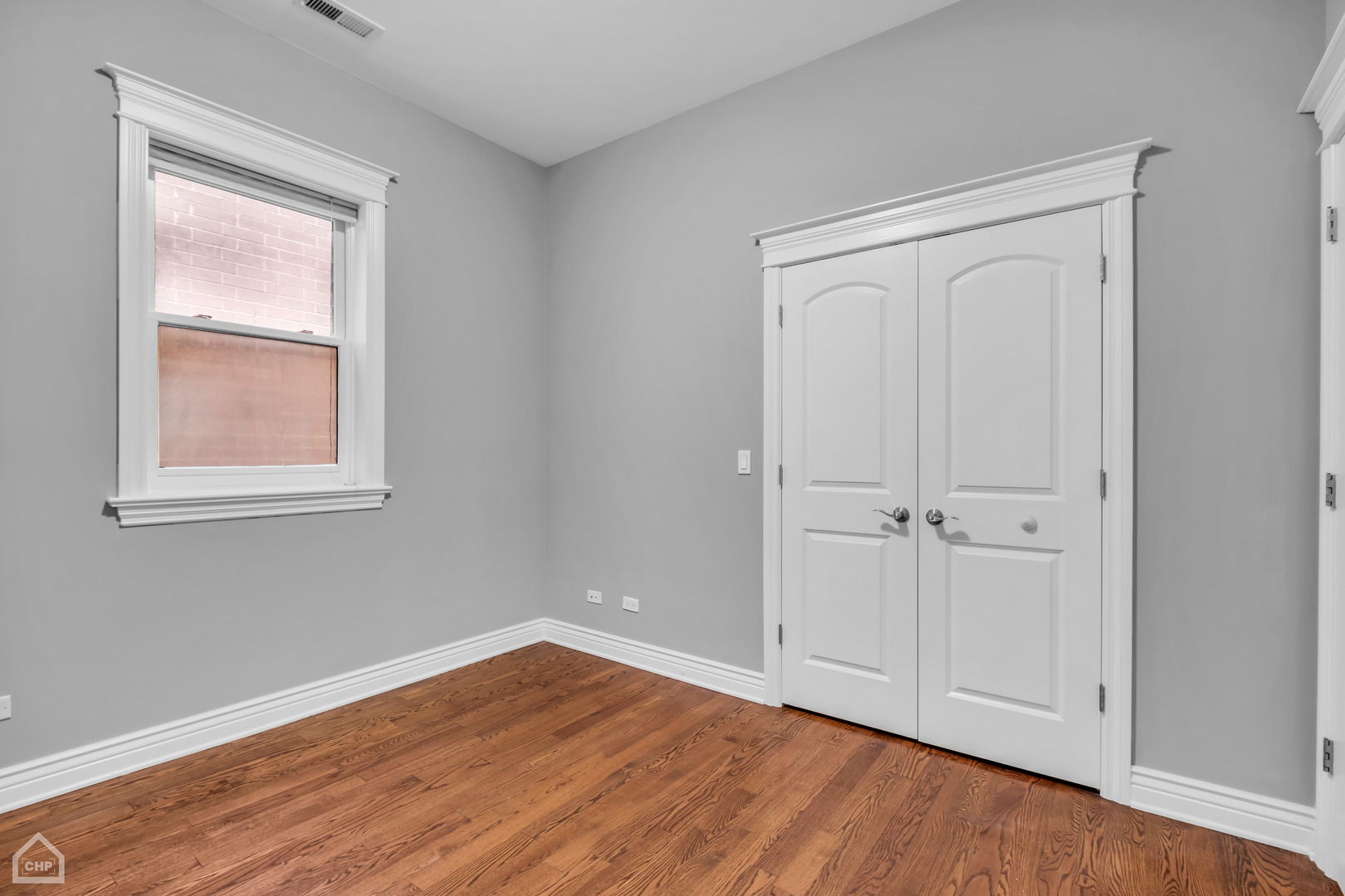 1248 West Jackson Boulevard, Unit 3E Chicago, IL 60607 - Photo 16 of 20 a view of an empty room with wooden floor and a window