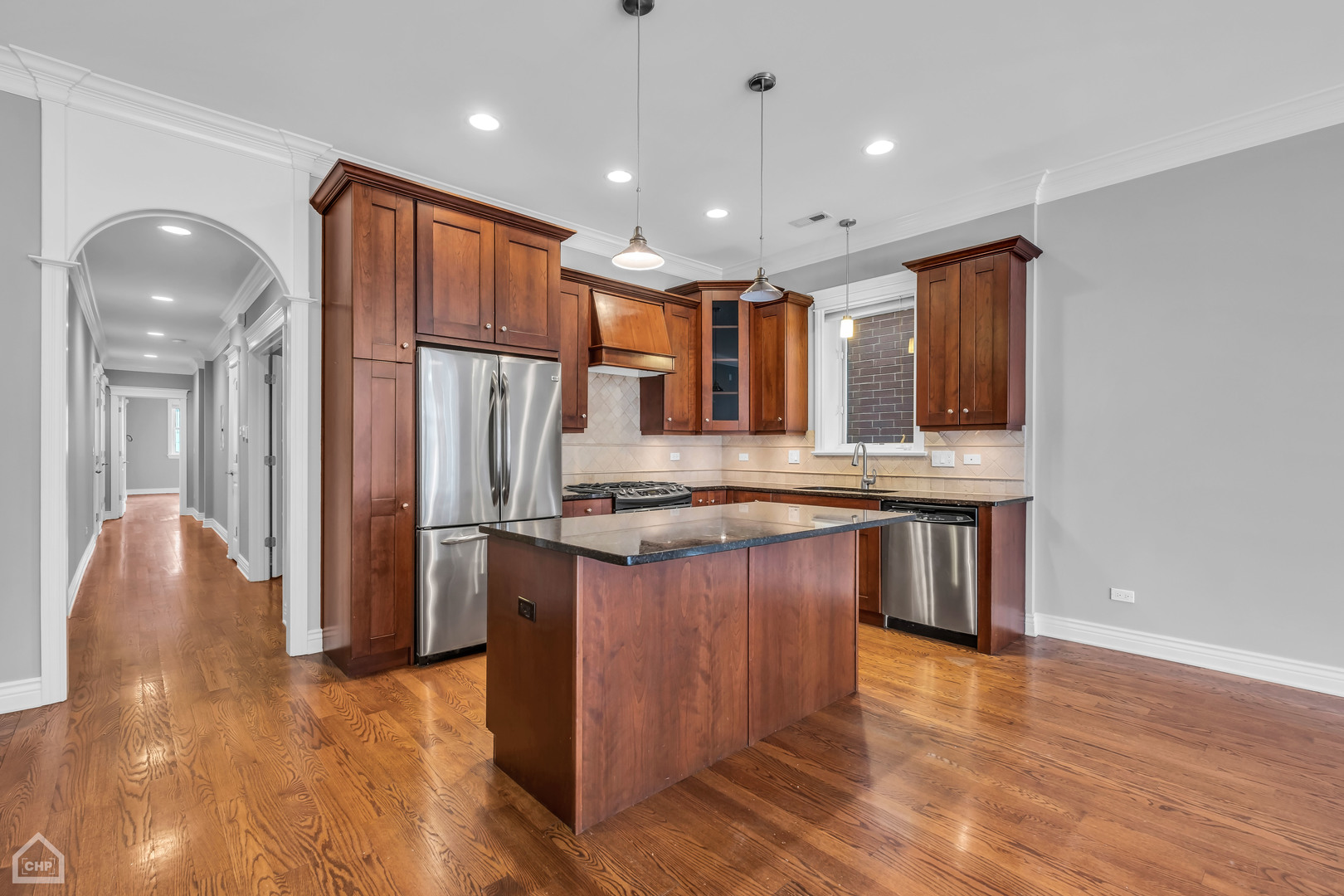 1248 West Jackson Boulevard, Unit 3E Chicago, IL 60607 - Photo 4 of 20 a kitchen with stainless steel appliances granite countertop a refrigerator a sink and a stove