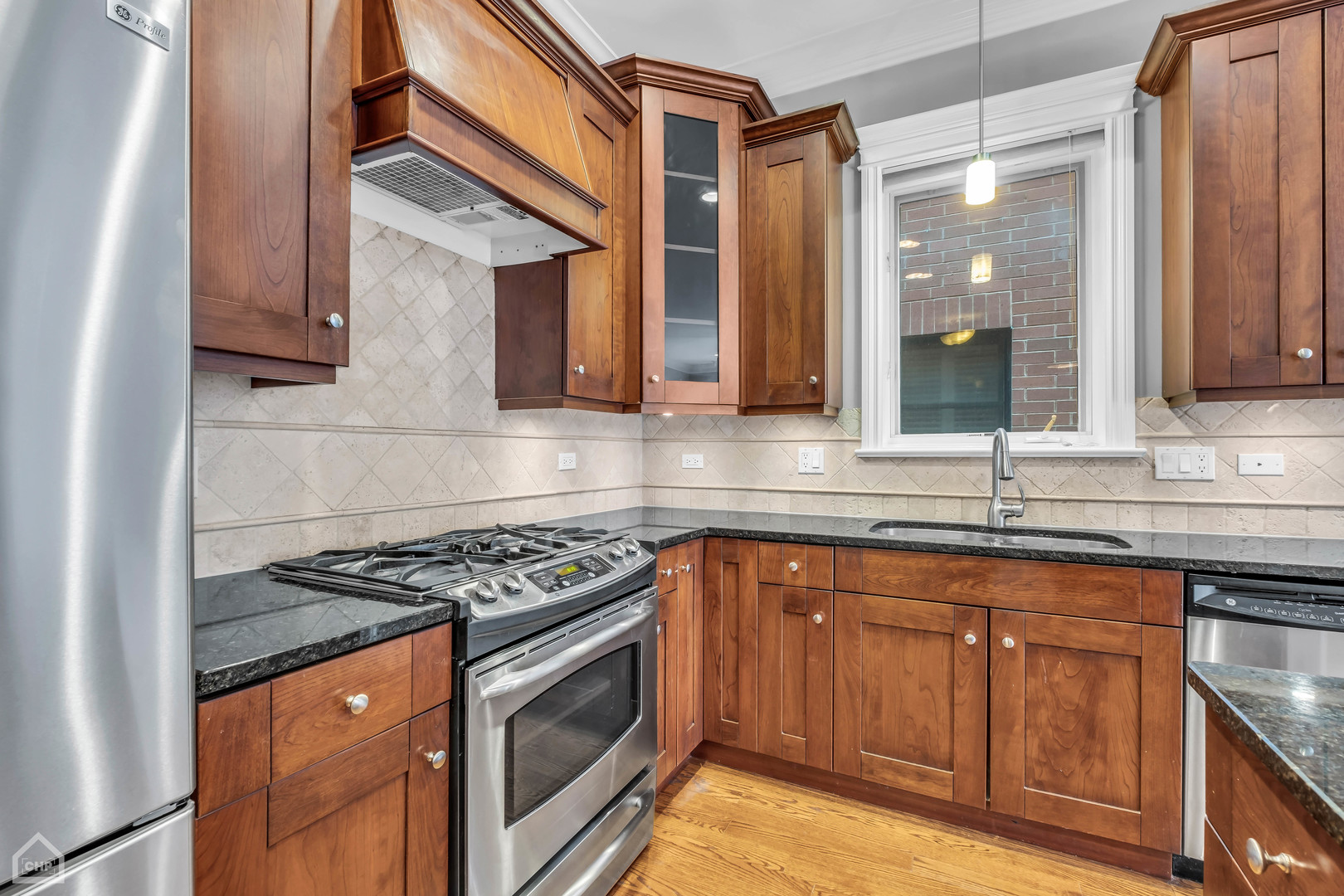 1248 West Jackson Boulevard, Unit 3E Chicago, IL 60607 - Photo 6 of 20 a kitchen with stainless steel appliances granite countertop a sink and a stove