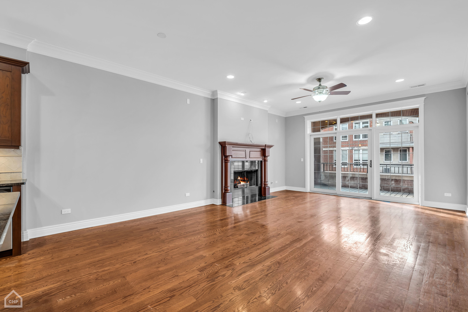 1248 West Jackson Boulevard, Unit 3E Chicago, IL 60607 - Photo 8 of 20 a view of an empty room with a window and wooden floor