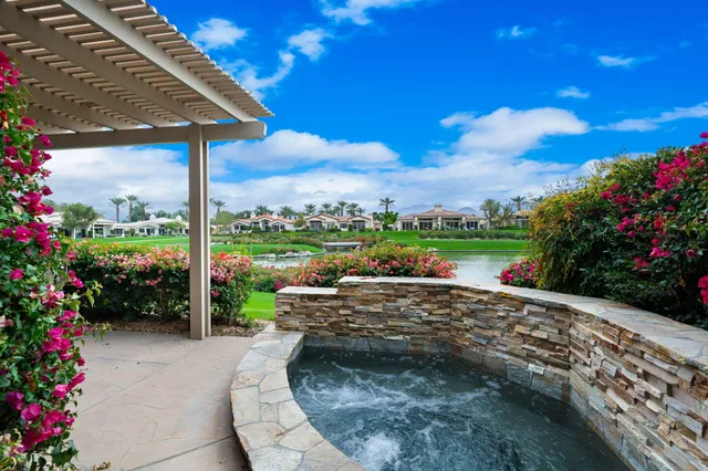 a view of a garden with a table and chairs in patio