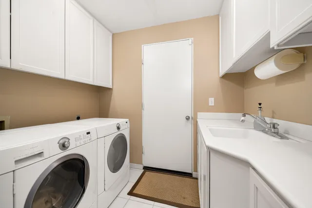 an aerial view of a house with a garden and lake view
