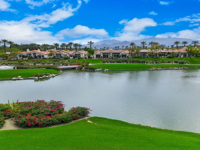 a wooden bench sitting in front of a house