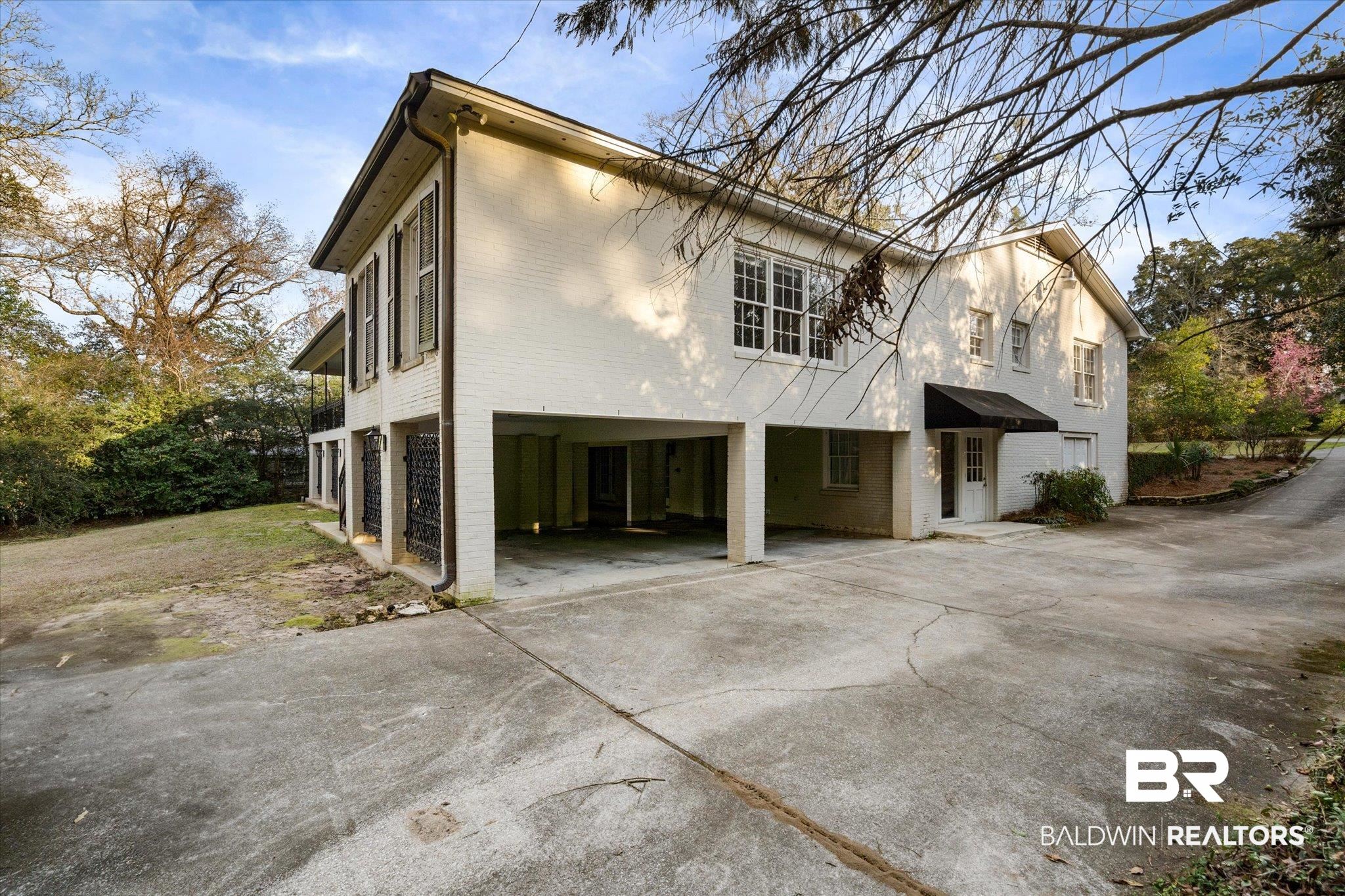 143 Myrtlewood Lane Mobile, AL 36608 - Photo 47 of 55 Exterior space with a carport, driveway, and brick siding