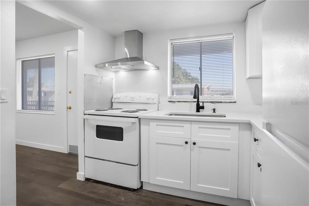 1522 Pleasant Road, Unit G23 Bradenton, FL 34207 - Photo 11 of 27 a kitchen with cabinets appliances and a wooden floor