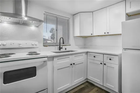 a kitchen with cabinets appliances and a sink
