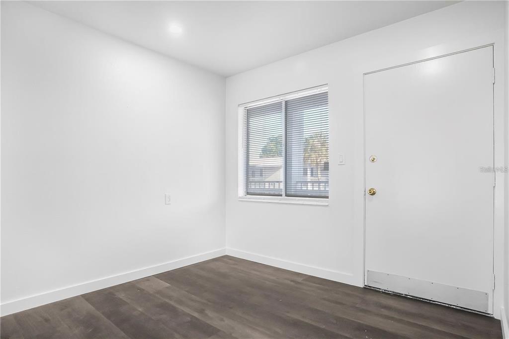 1522 Pleasant Road, Unit G23 Bradenton, FL 34207 - Photo 8 of 27 an empty room with wooden floor and windows