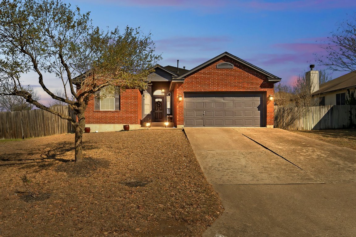 a yellow house with trees in front of it