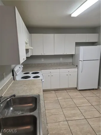 a kitchen with cabinets and appliances