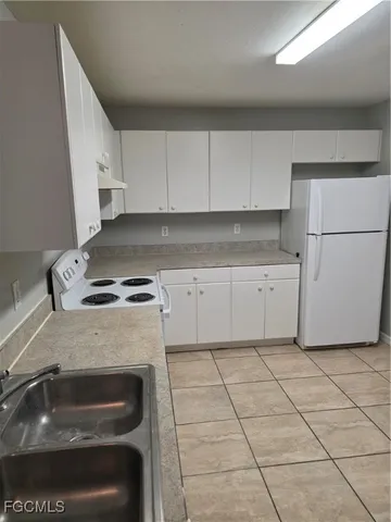 a kitchen with cabinets and appliances