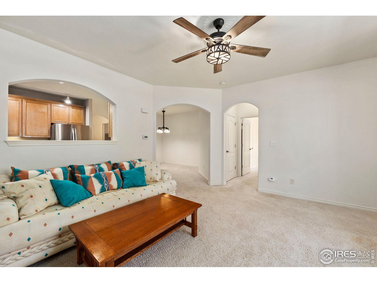 4672 West 20th Road, Unit 2212 Greeley, CO 80634 - Photo 11 of 40 Arched entries create an expansive feeling in the living room and a gas fireplace ensures a welcoming atmosphere.