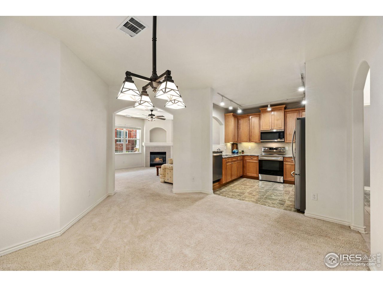 4672 West 20th Road, Unit 2212 Greeley, CO 80634 - Photo 14 of 40 The dining area is open to the kitchen and accented with designer lighting