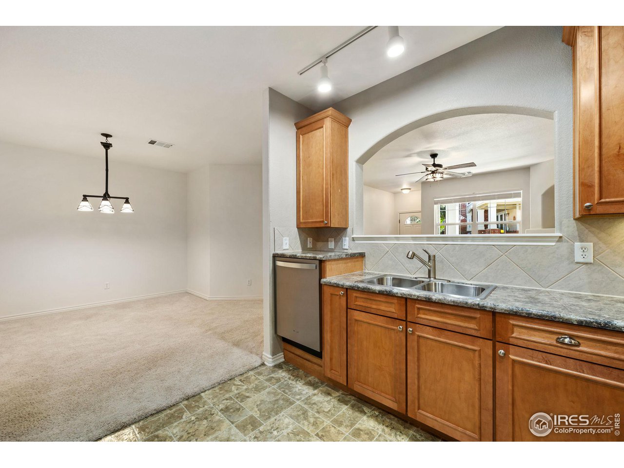 4672 West 20th Road, Unit 2212 Greeley, CO 80634 - Photo 21 of 40 Crown molding accents the natural maple wood grain of the abundant cabinets and the stainless steel of the appliances gives the kitchen a modern feel.