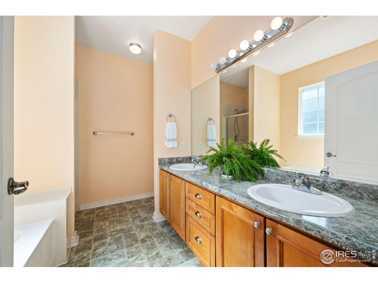 4672 West 20th Road, Unit 2212 Greeley, CO 80634 - Photo 25 of 40 The primary suite is upgraded to a 5-piece full bath and offers a walk in closet.