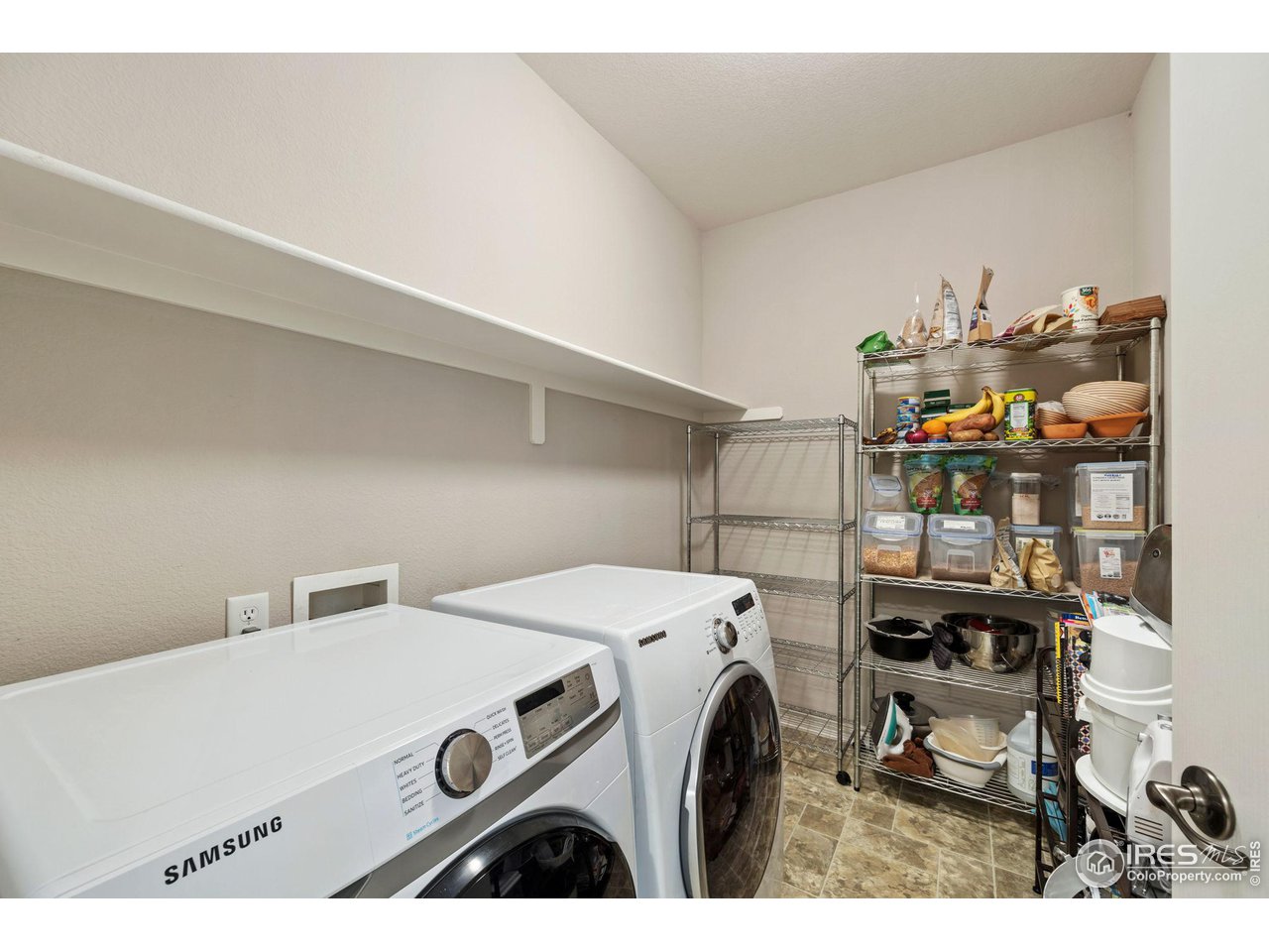 4672 West 20th Road, Unit 2212 Greeley, CO 80634 - Photo 35 of 40 Laundry room with storage shelf