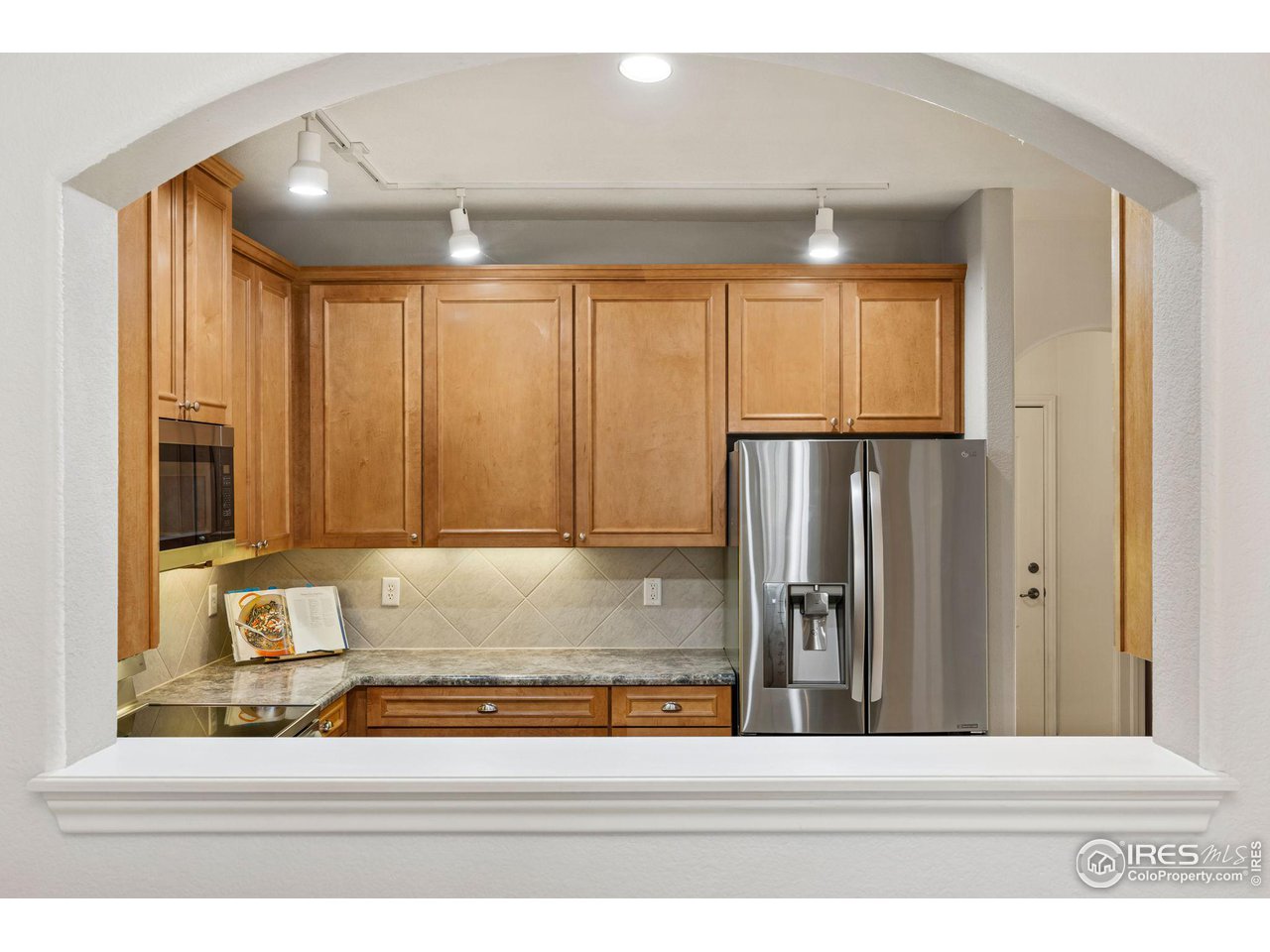 4672 West 20th Road, Unit 2212 Greeley, CO 80634 - Photo 6 of 40 Crown molding accents the natural maple wood grain of the abundant cabinets and the stainless steel of the appliances gives the kitchen a modern feel.